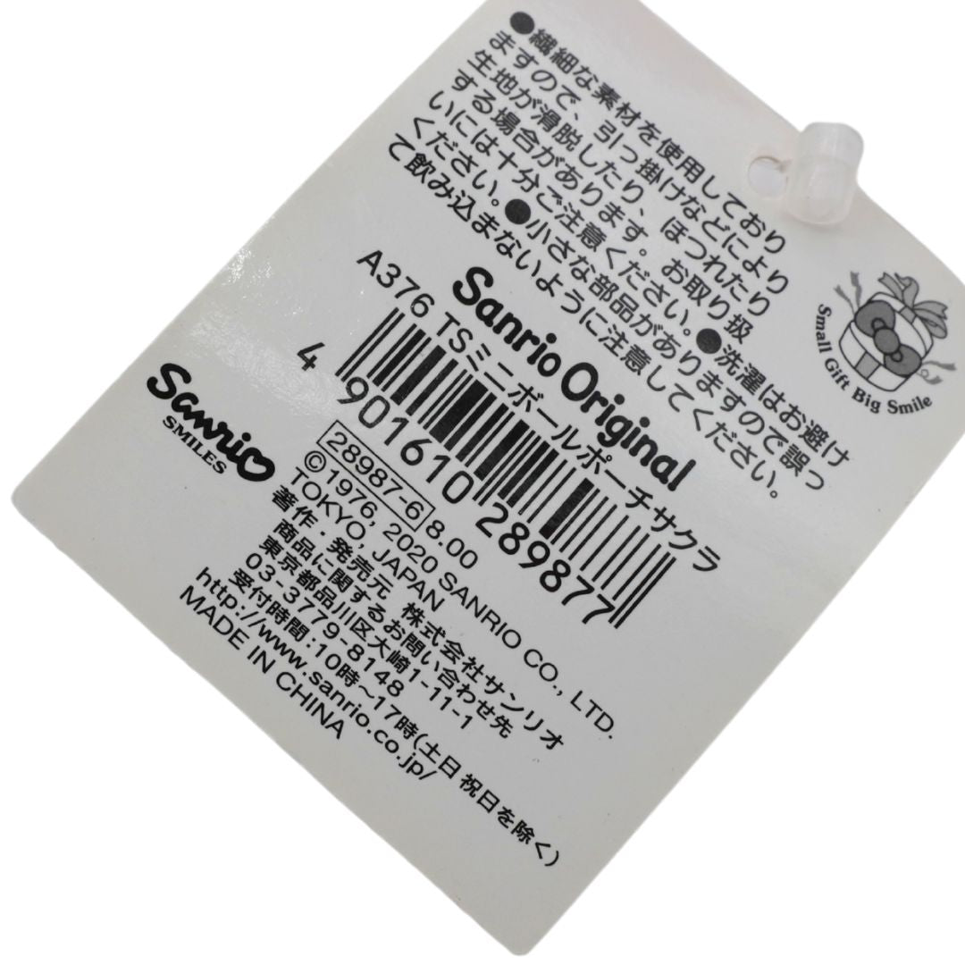 A white paper hangtag with black printed text, barcode, and Sanrio branding, photographed on a plain white background.