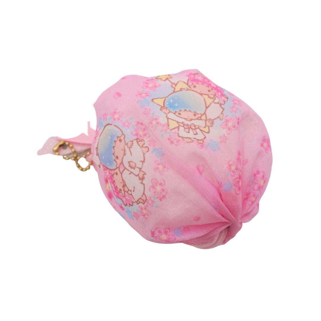 A pink fabric drawstring pouch featuring a cartoon character print, shown on a plain white background.