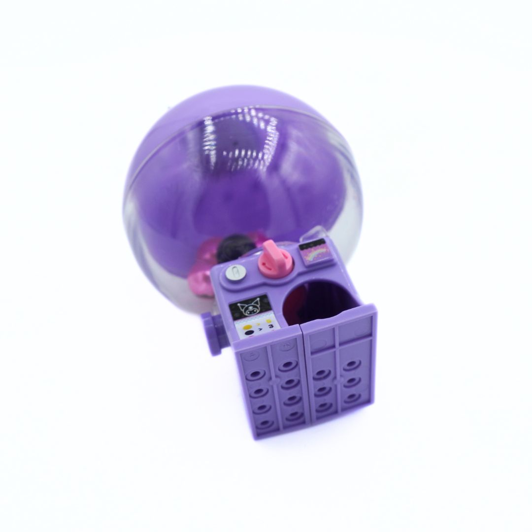 A purple toy that looks like a gumball machine on a white background