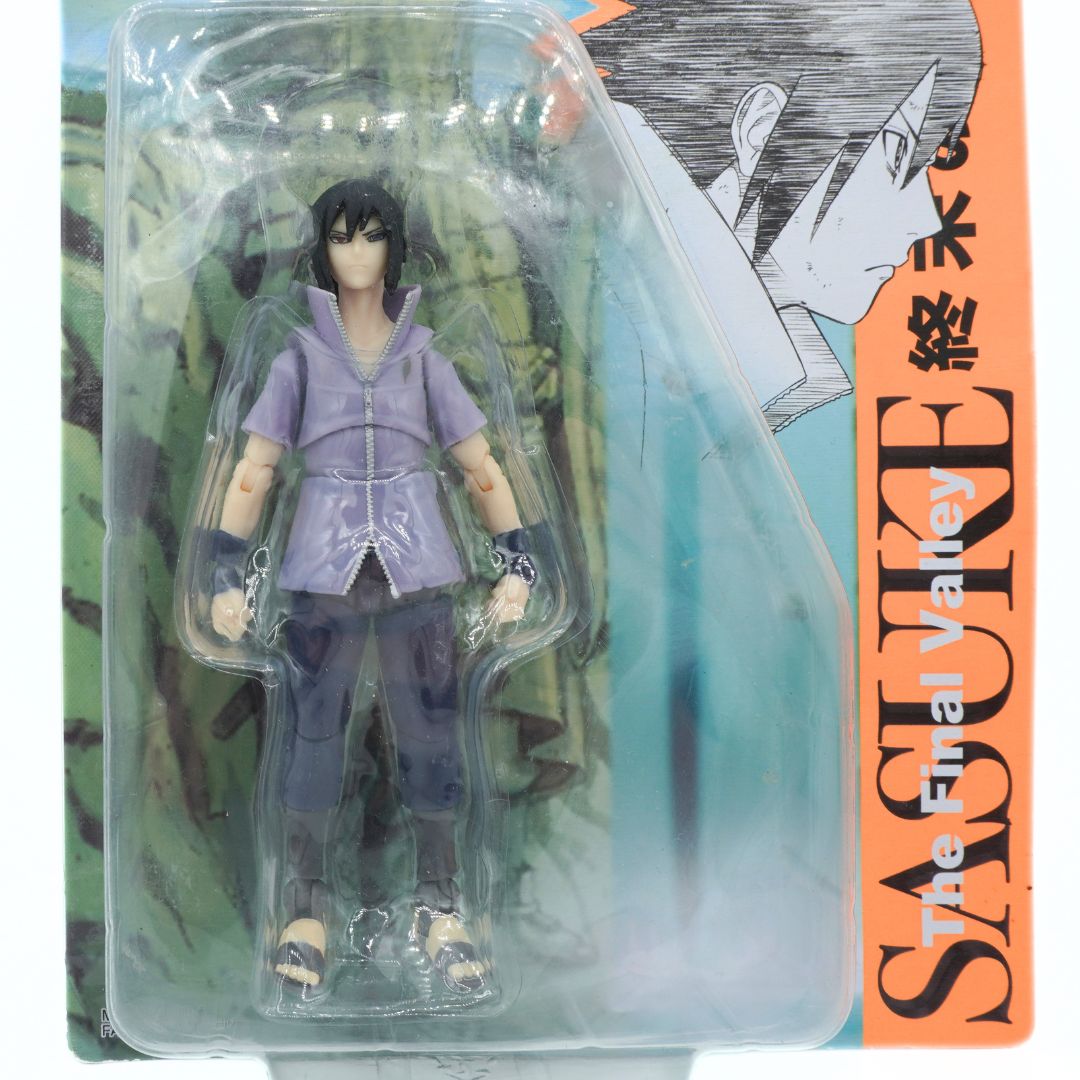 Action figure in packaging with 'Sasuke' text on an orange background