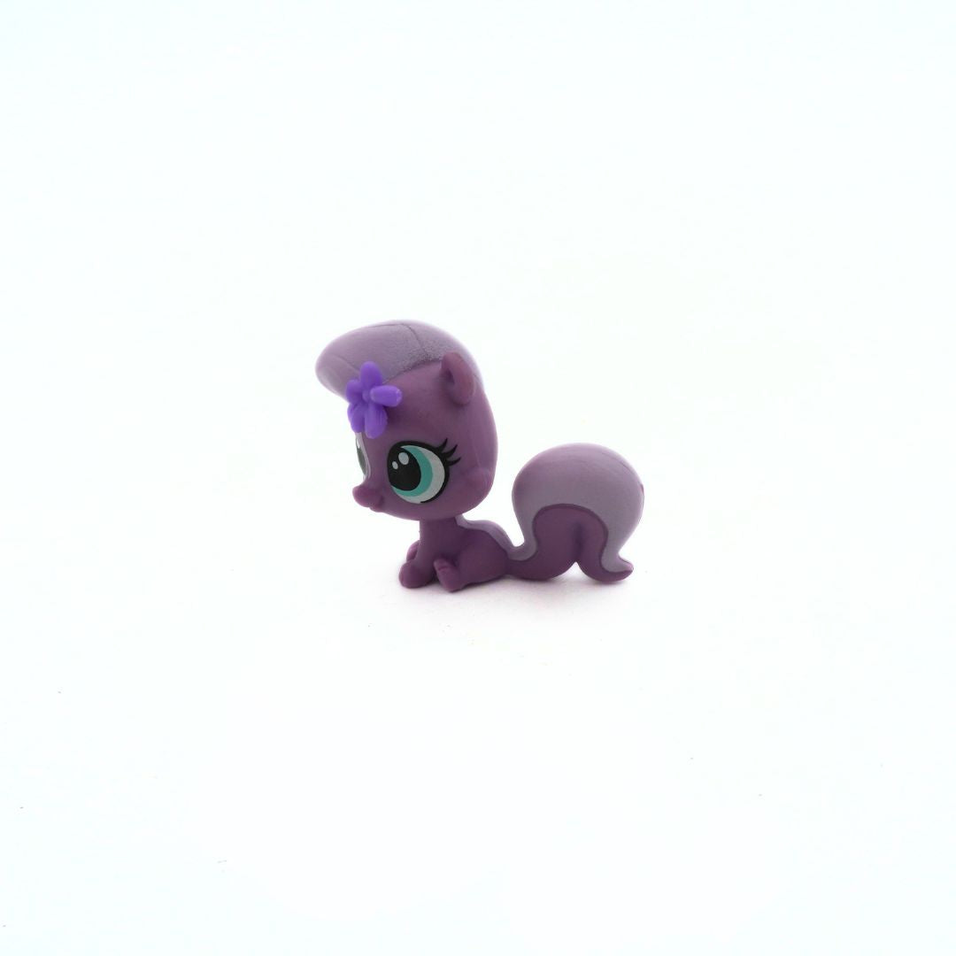 Purple toy figure with a bow on a white background