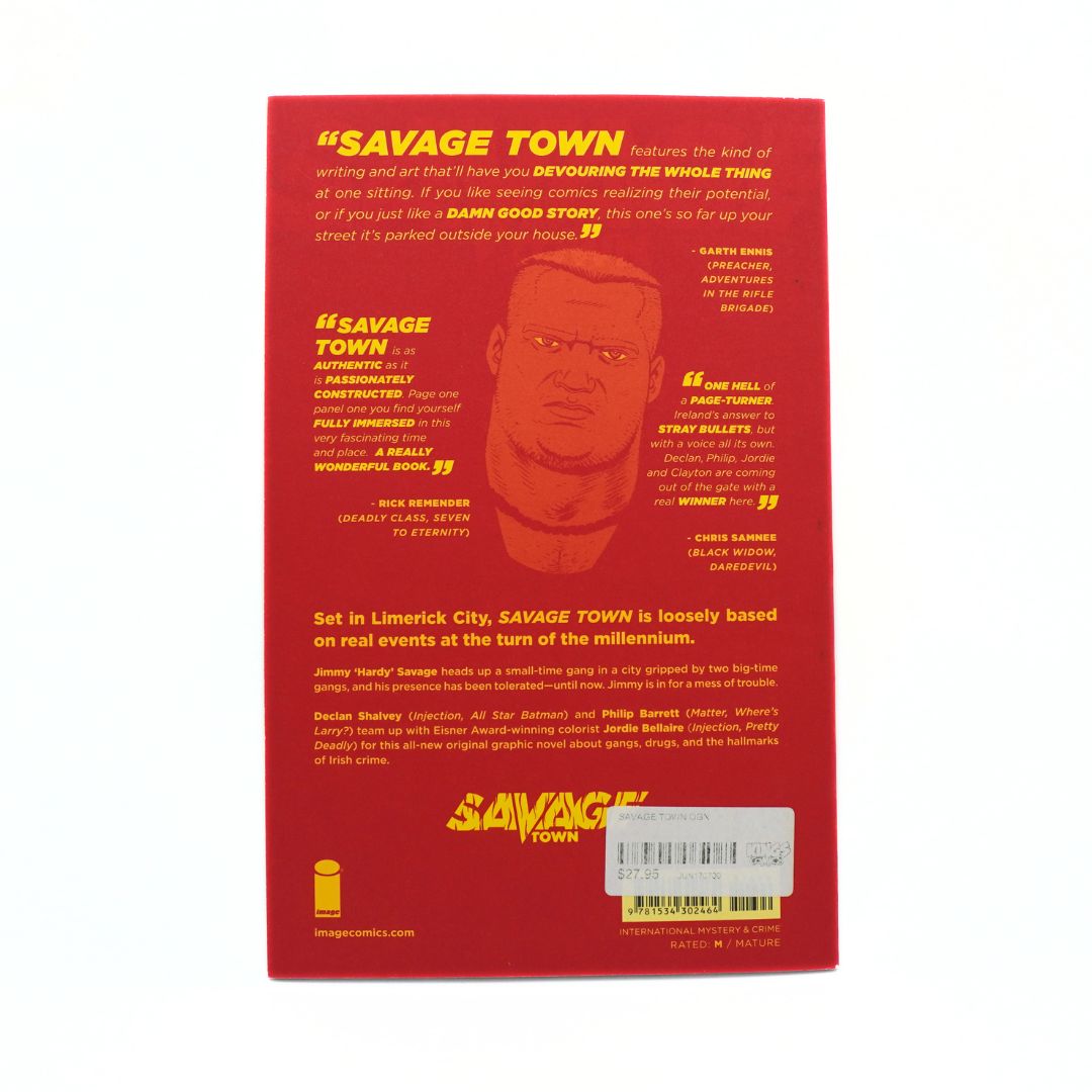 The back cover of a 'Savage Town' comic book, featuring a red background with a large black-and-white illustration of a man's face, yellow text, and a white barcode sticker at the bottom.