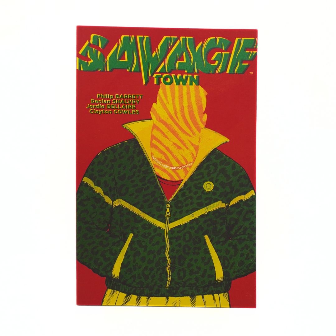 A comic book or art print titled 'SAVAGE TOWN' featuring a stylized figure in a green and yellow patterned jacket against a red background, photographed on a plain white surface.