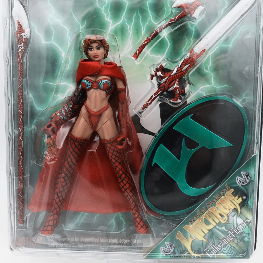 Close up photo of the 1998 Scarlet Medieval Witchblade figurine with her accessories