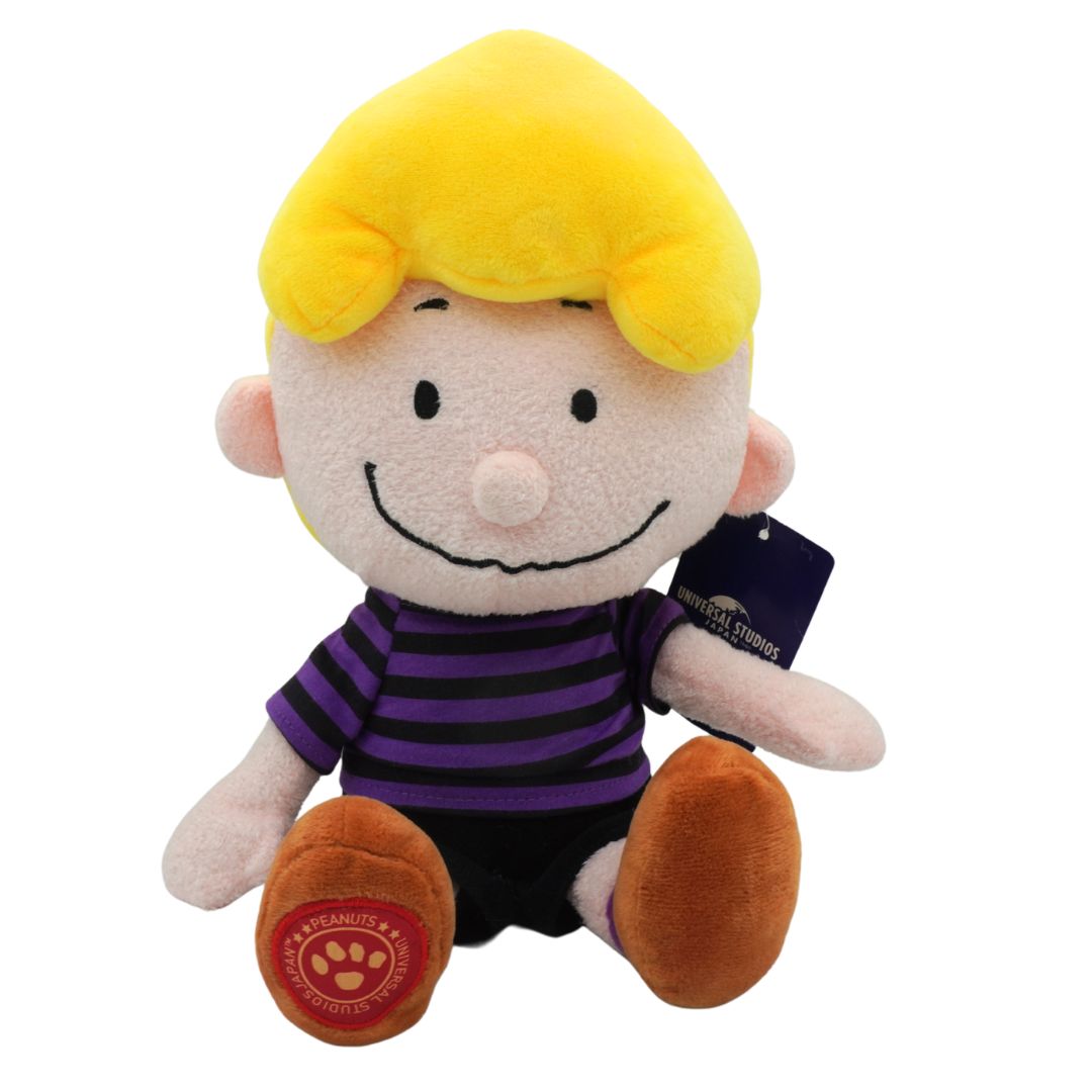 Plush toy resembling a character with yellow hair and purple striped shirt on a white background
