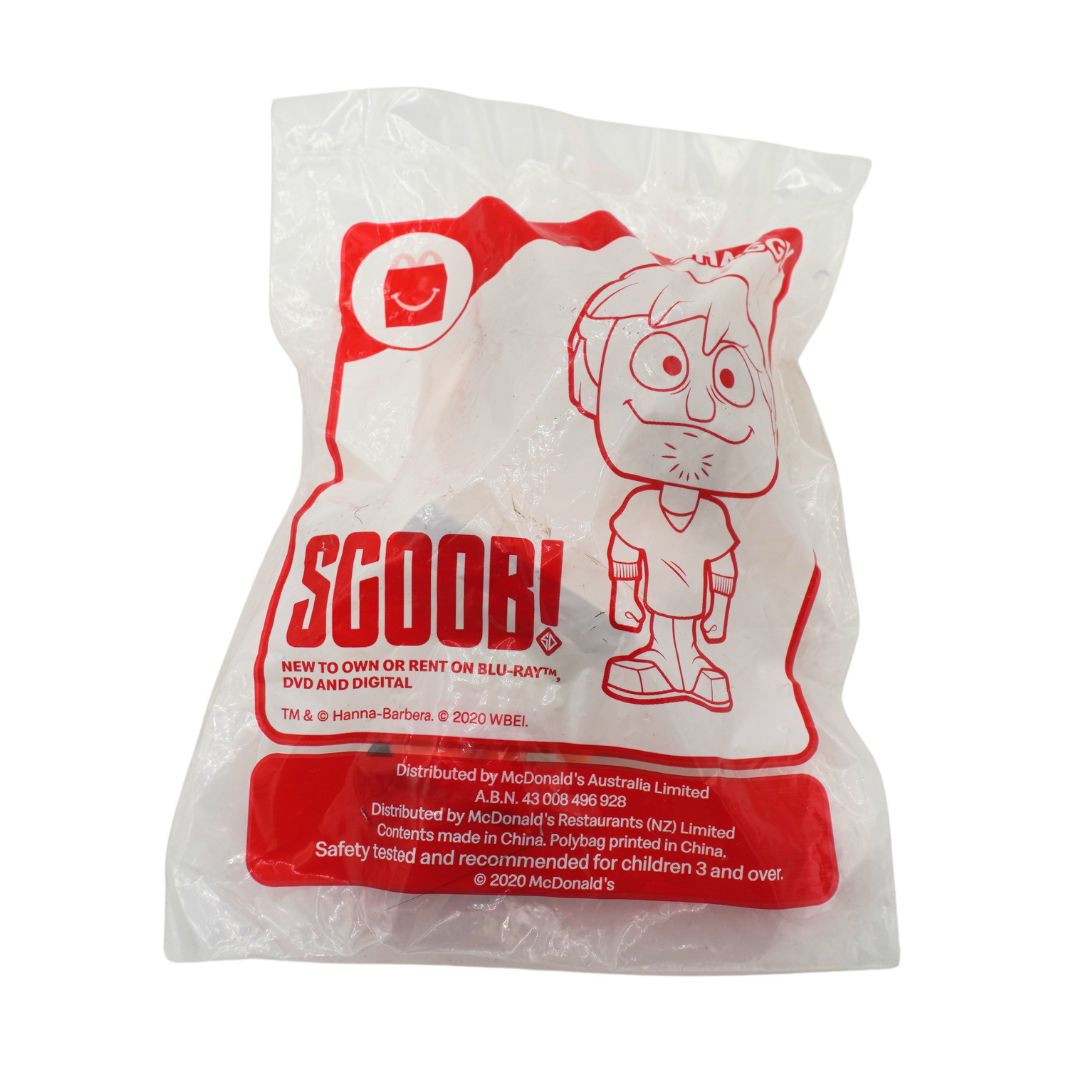 A sealed plastic bag containing a Scoob! toy, with red printed graphics and text on a white background. Visible branding includes Scoob! and McDonald's.