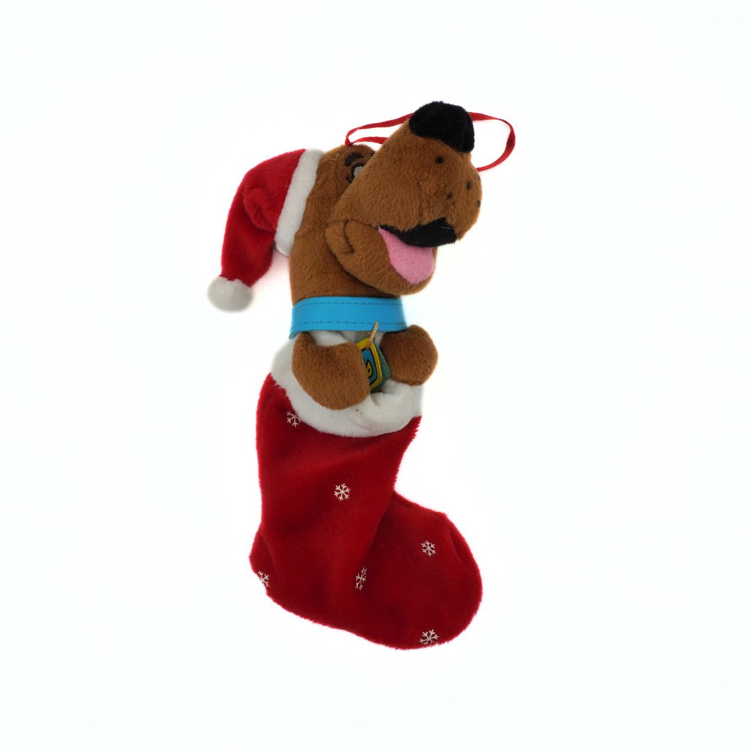 Plush dog toy with a Santa hat inside a red stocking on a white background