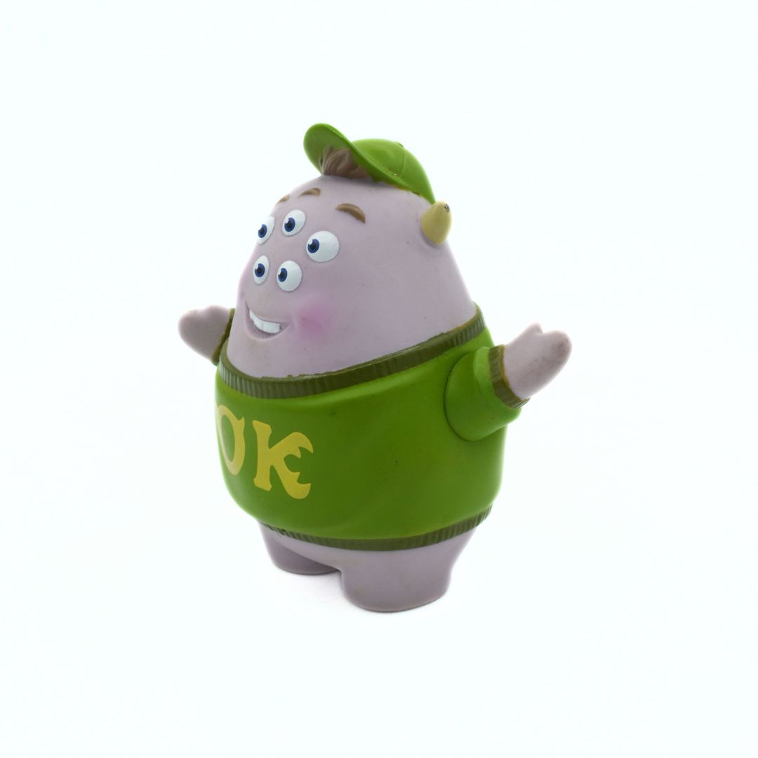 Cartoon character toy with a green sweater on a white background