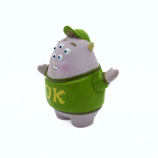 Cartoon character toy with a green sweater on a white background