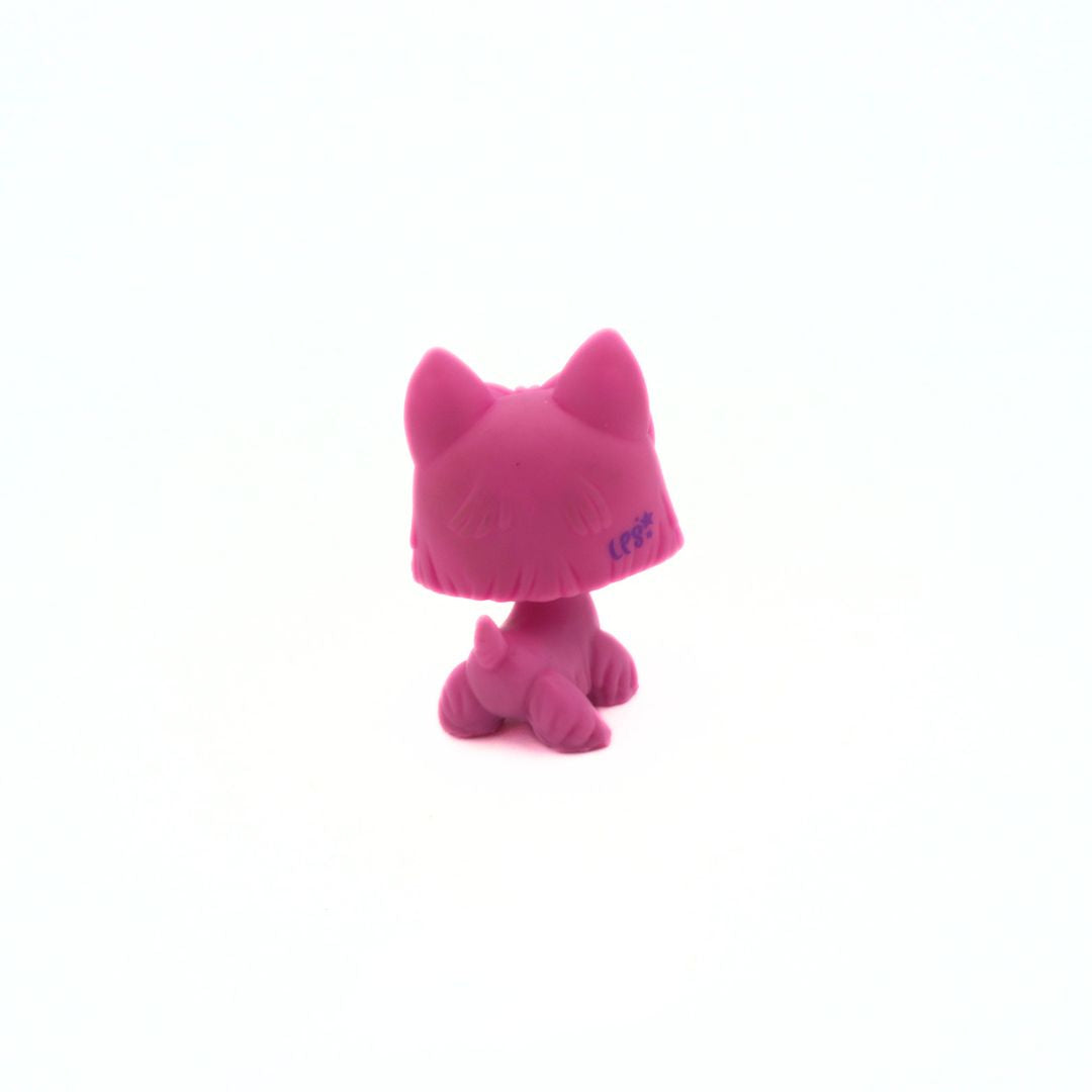 Pink plastic toy with pointy ears on a white background