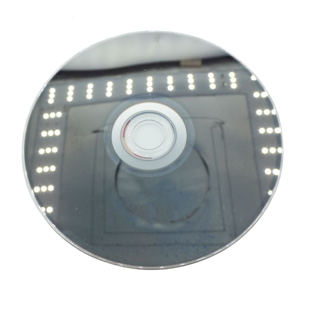 Wii U disc taken inside a light box with the LED lights reflect on the disc