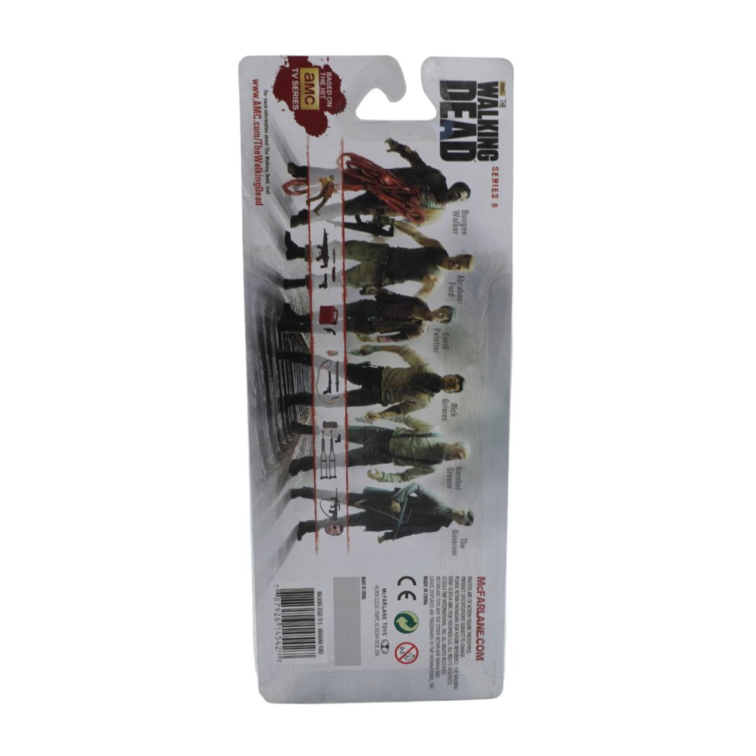 Packaged toy figures from 'The Walking Dead' series on a white background