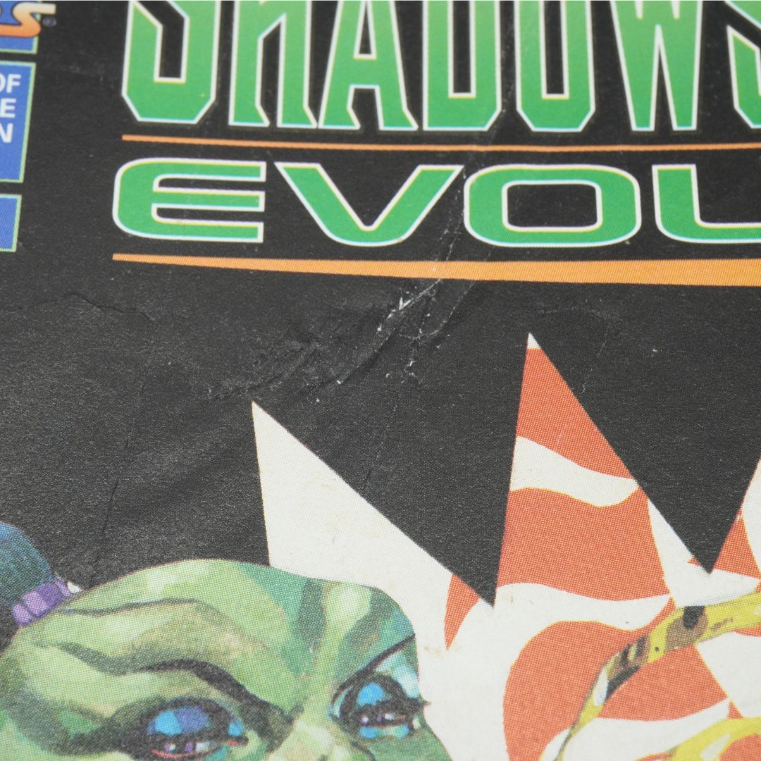 Close-up of a comic book cover with 'Shadows Evolve' text and character illustration.