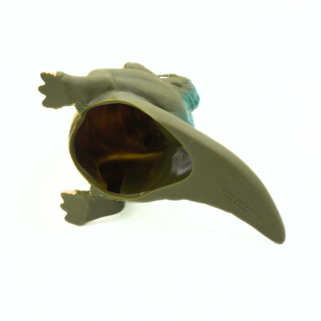 Toy figure of a character with a long tail on a white background