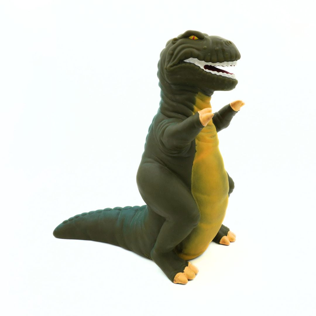 Plastic toy dinosaur with green and yellow colors on a white background