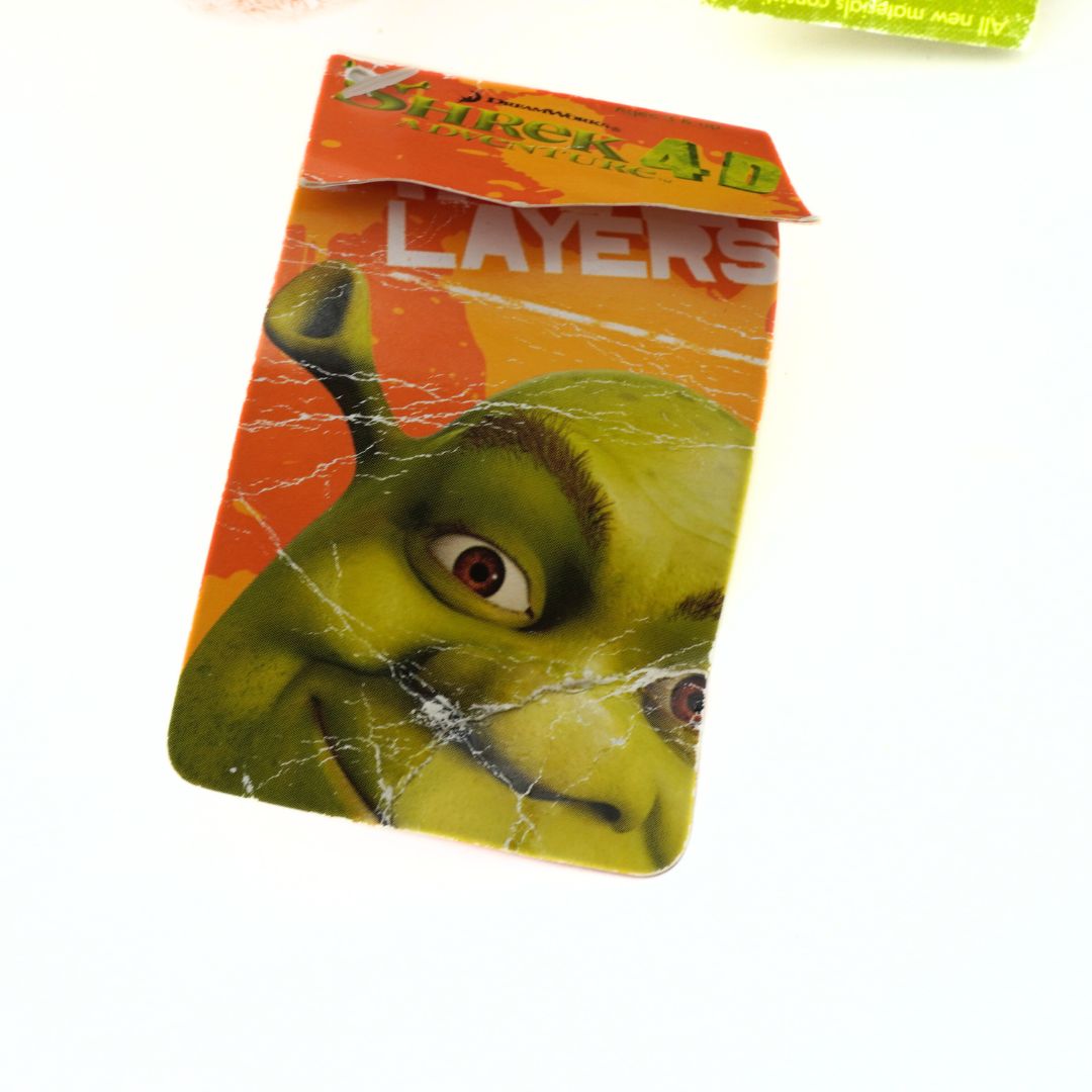 Packaging of 'Shrek' themed product with a green character on an orange background