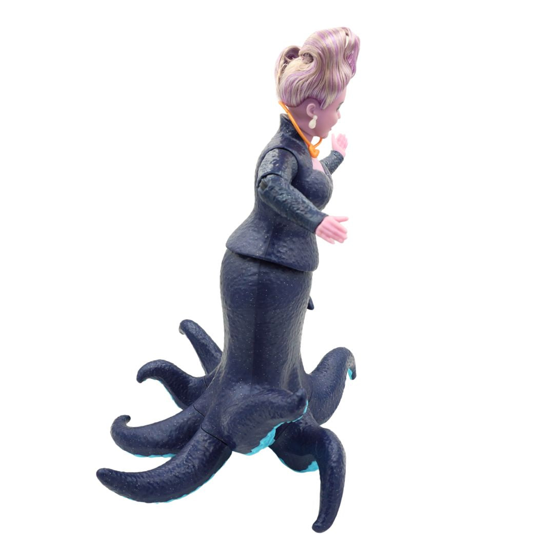 Ursula doll wearing a dark blue dress and with purple hair