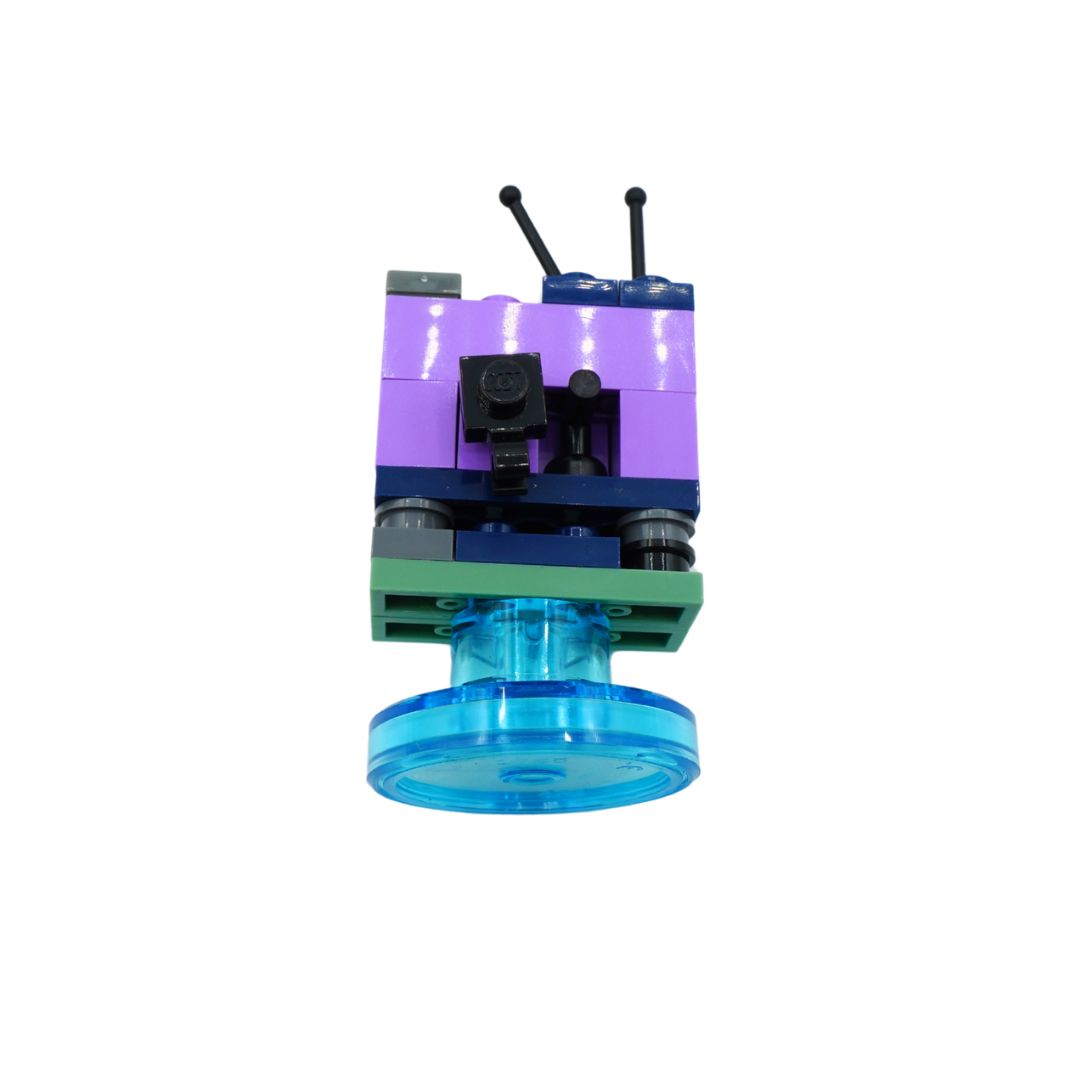 A custom-built toy structure resembling a small robot or camera unit, constructed from interlocking plastic building blocks. It features a purple upper section with two black antenna-like pieces, a green base plate, a dark blue middle section with a black camera-like piece, and a translucent blue circular base.