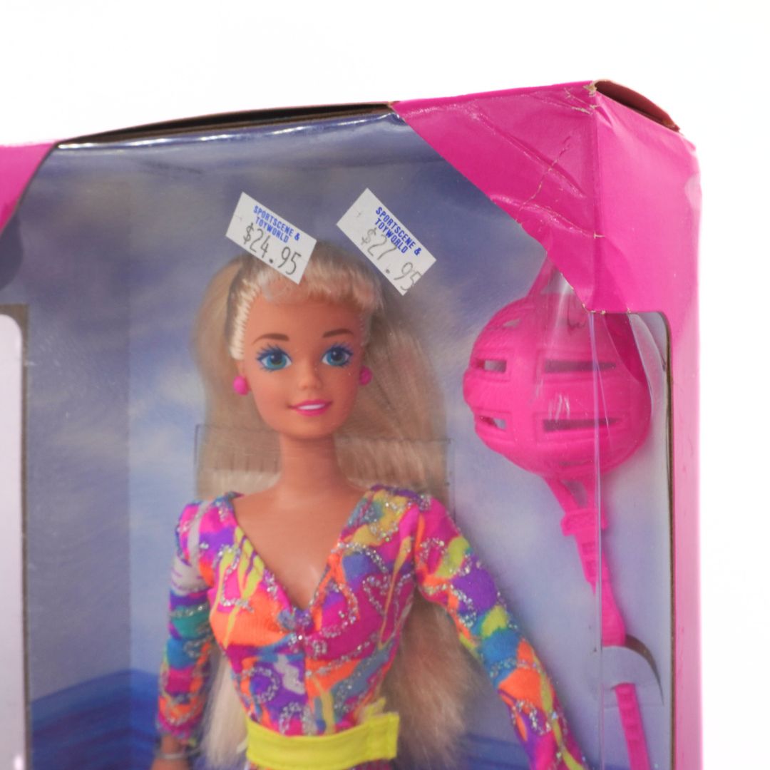 Barbie doll in packaging with pink hairbrush, vintage design