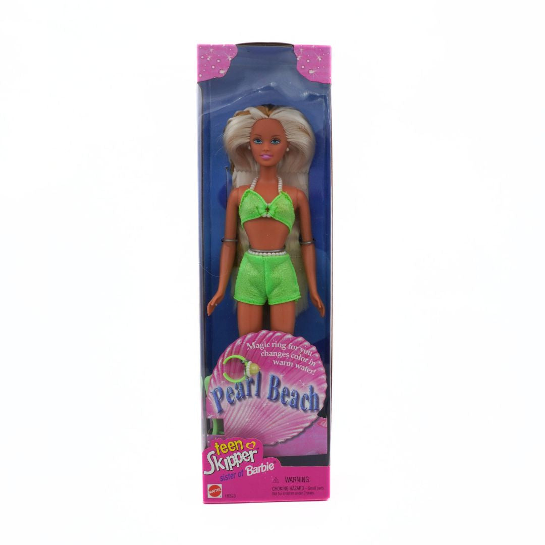 Barbie doll in green swimsuit packaging on a white background