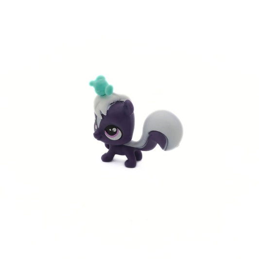 Small figurine with a purple body and white tail on a white background