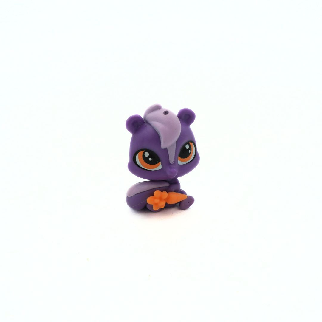 Small purple skunk toy from Littlest Pet Shop with an orange carrot and orange eyes