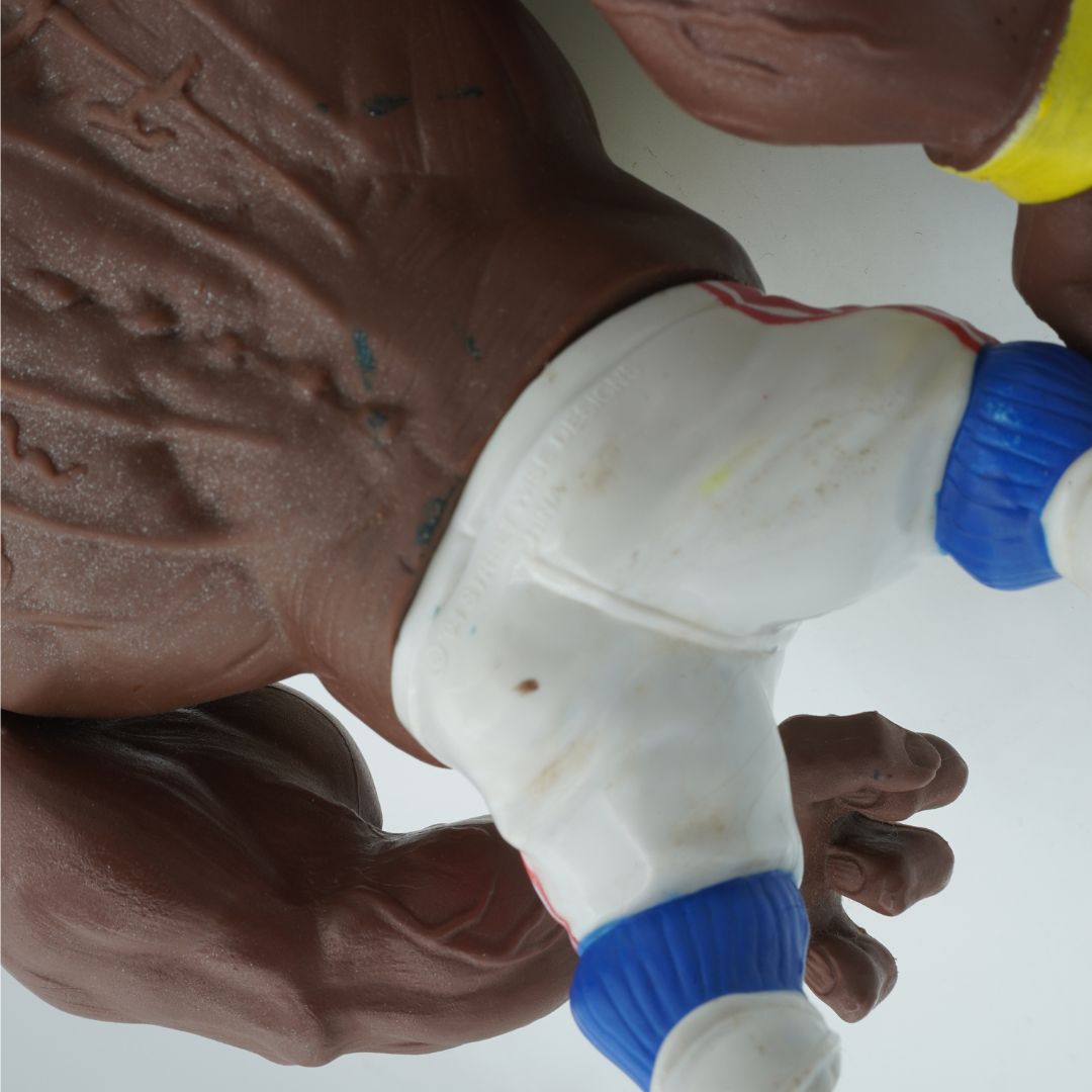 Closeup of the back of a brown Street Shark wearing white and blue pants