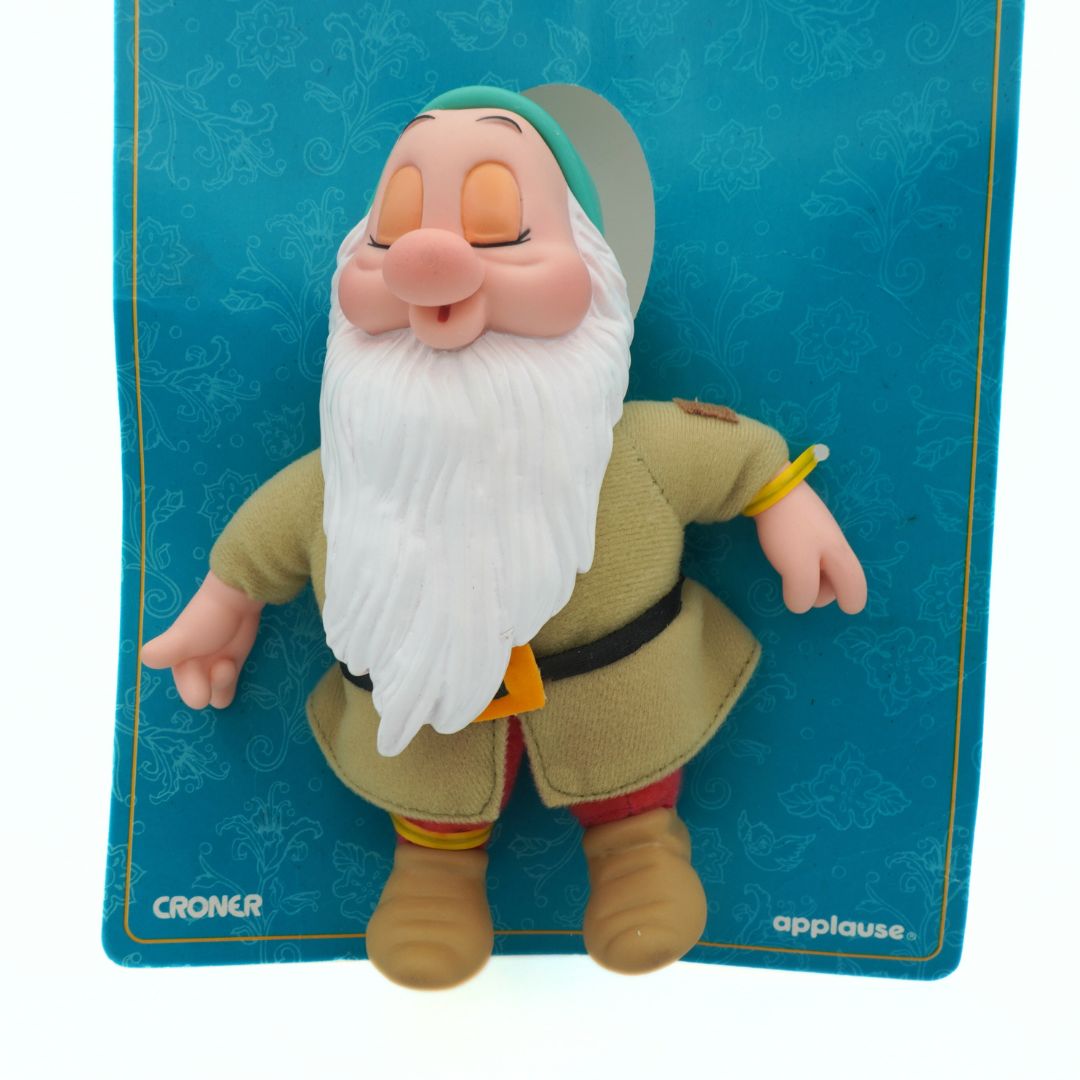 Toy figure of a character with a white beard on a blue card with 'Croner' and 'Applause' branding.