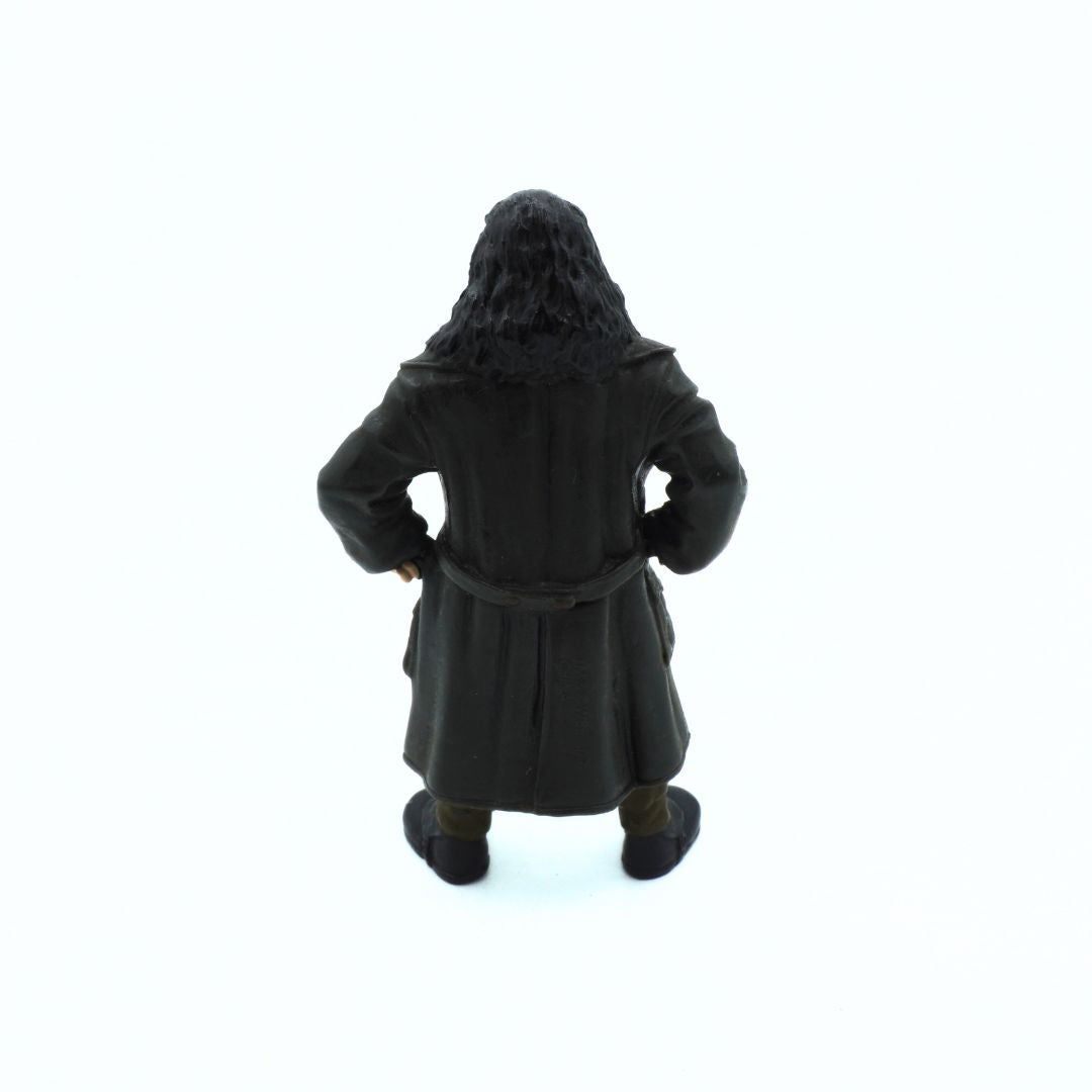 Figure of a character in a dark robe and hood on a white background
