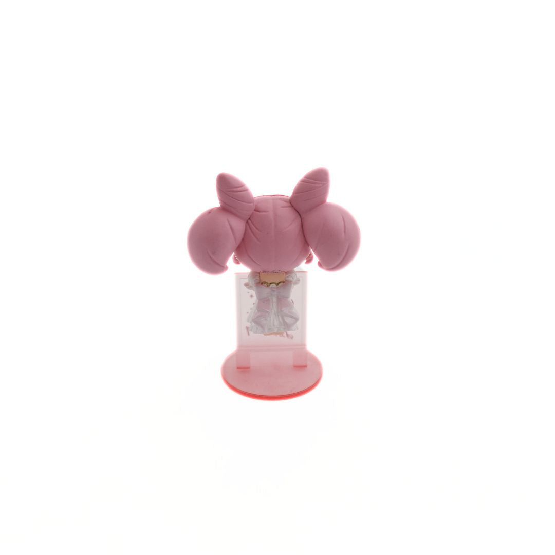 A photo of the back of a mini figurine of the Sailor Moon Character Small Lady Serenity balancing on a translucent pink wall