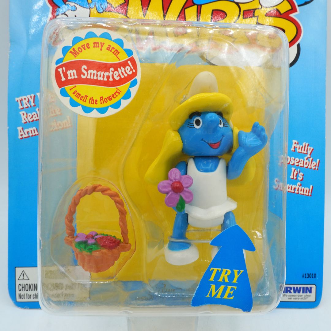 Toy figure of a character from Smurfs in packaging with promotional text.