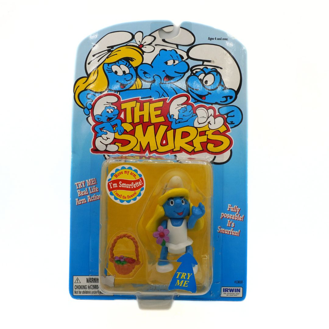 Smurf figure in packaging with 'The Smurfs' branding on a white background