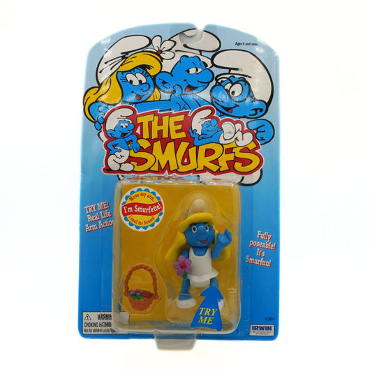 Smurf figure in packaging with 'The Smurfs' branding on a white background