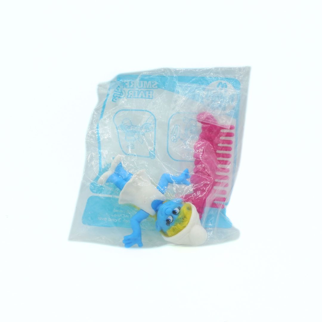 Toy figure in a clear plastic package on a white background