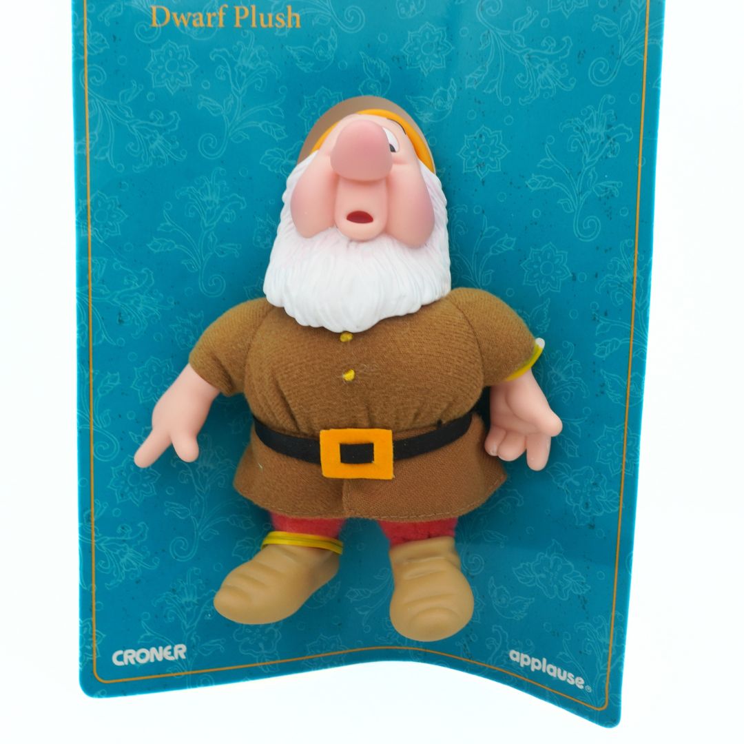 Plush toy of a dwarf on a blue packaging background
