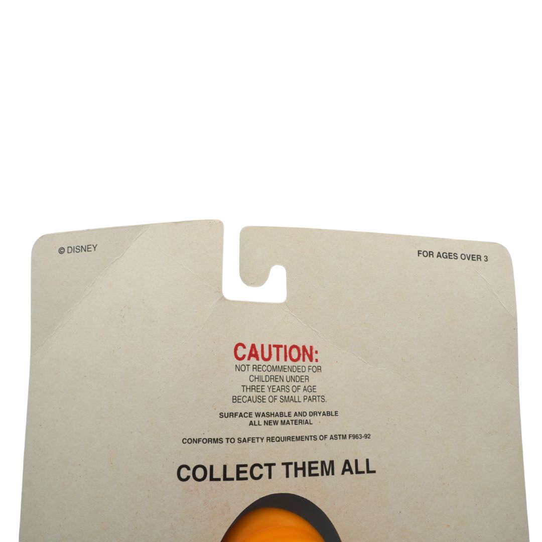 Cardboard toy packaging with a pull tab and safety warning text on a white background