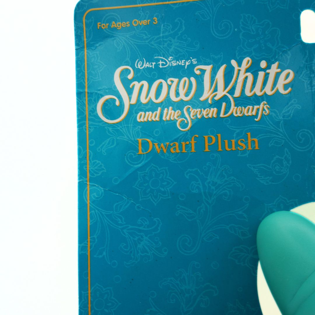 Blue packaging of Walt Disney's Snow White and the Seven Dwarfs Dwarf Plush with decorative patterns.