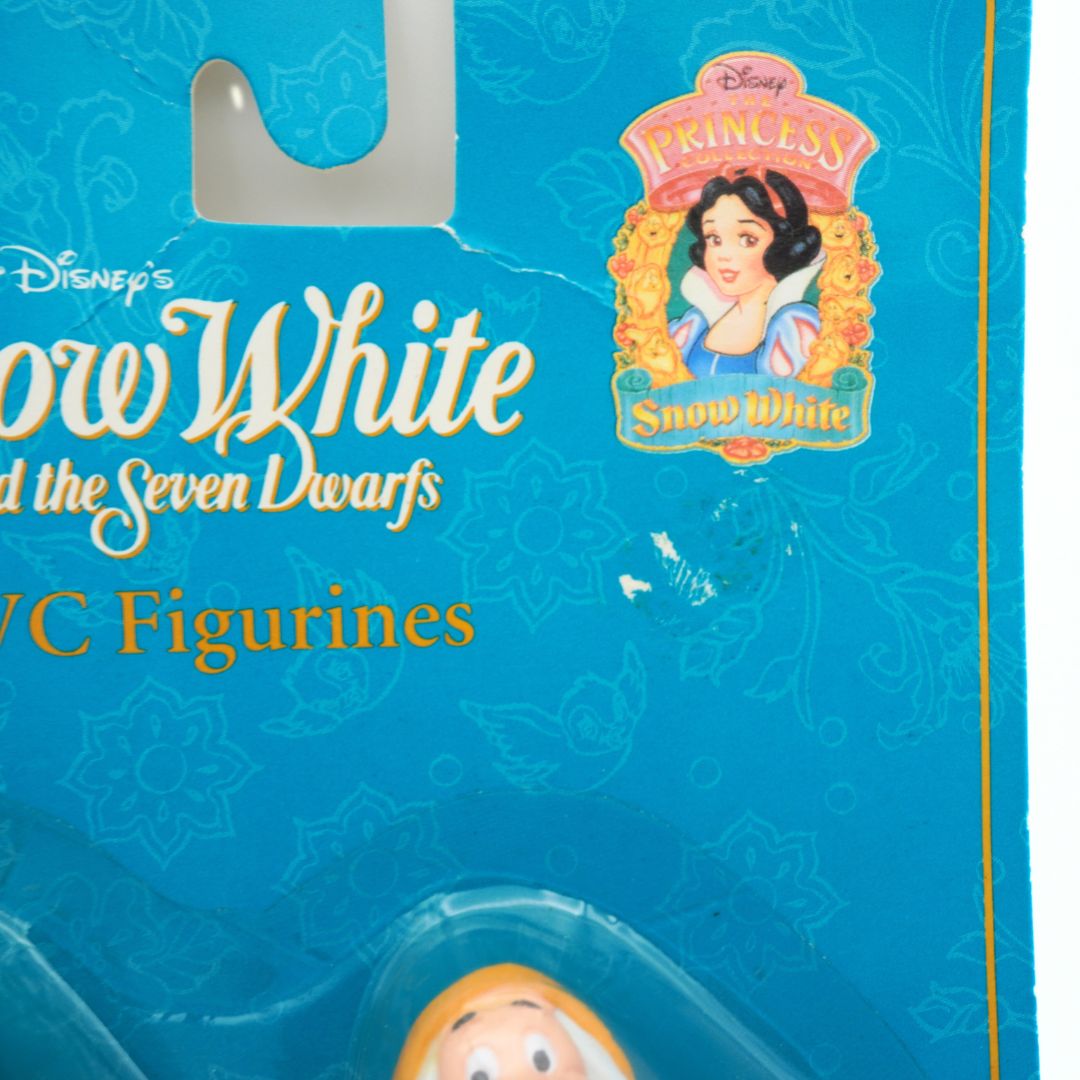 Packaging of Disney's Snow White and the Seven Dwarfs toy set with Snow White figure visible.