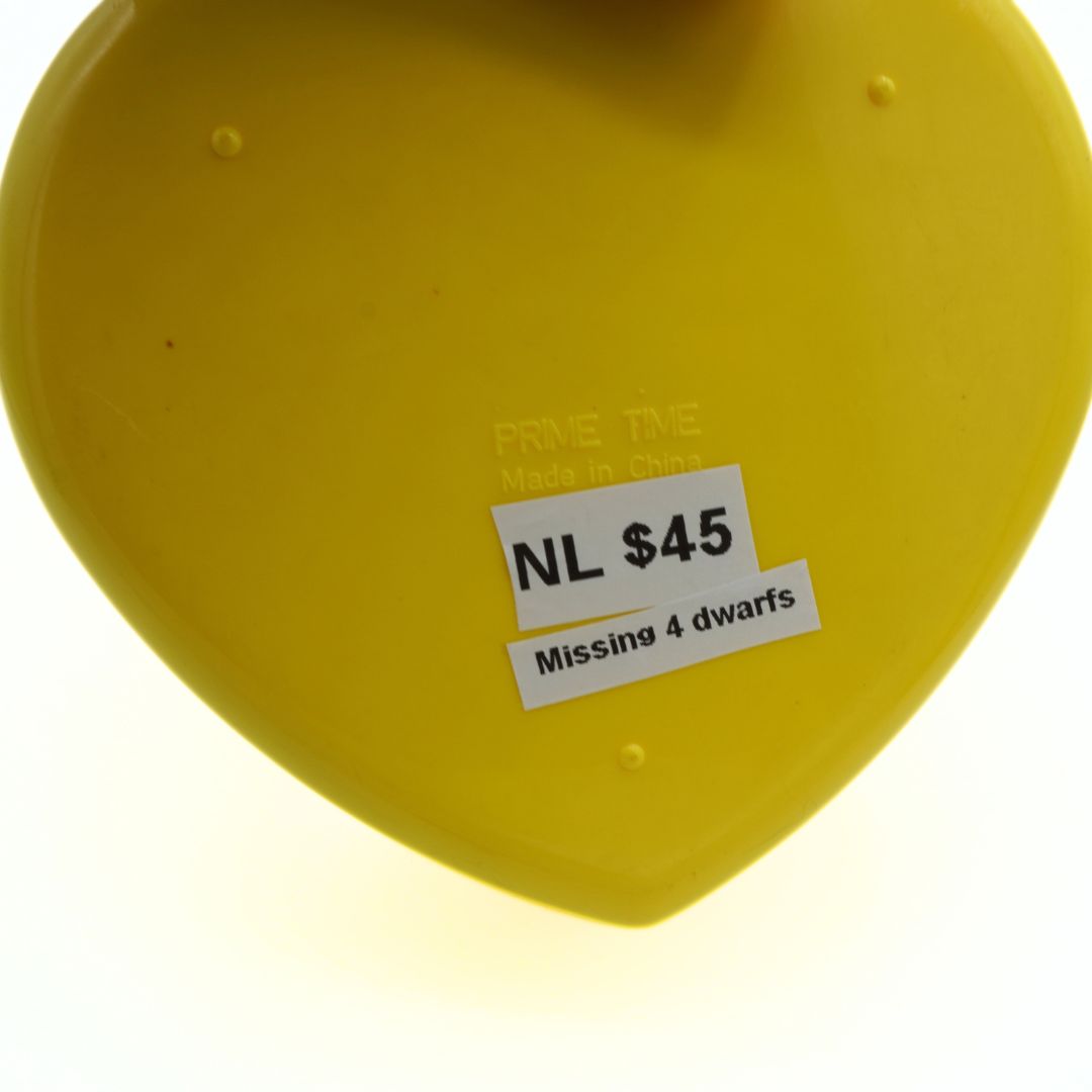 Yellow heart-shaped object with a label on a white background