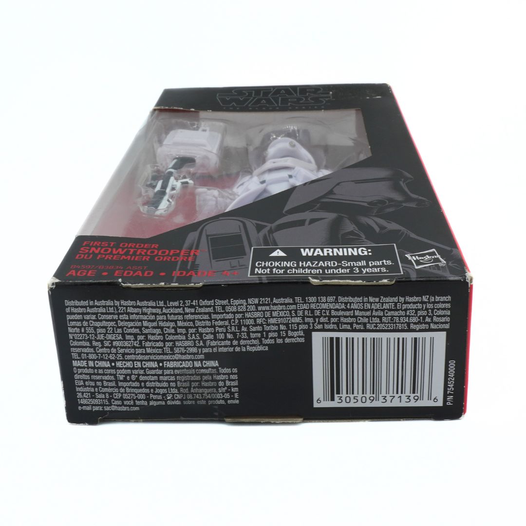Bottom view of a toy figure packaging with branding and warning labels.