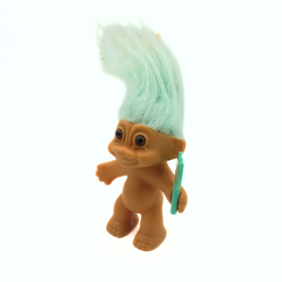 Toy figure with a green mohawk on a white background