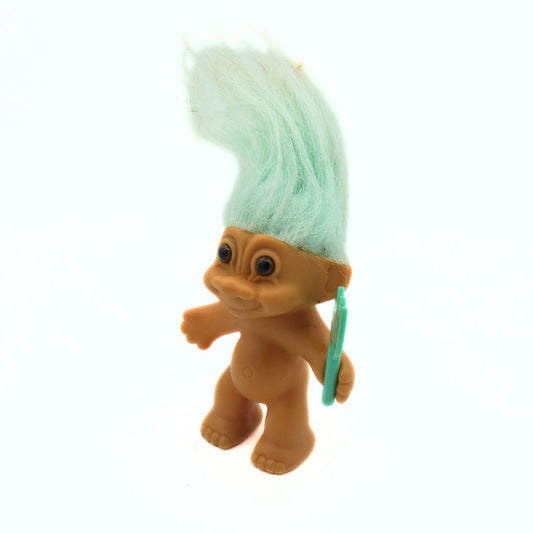 Toy figure with a green mohawk on a white background