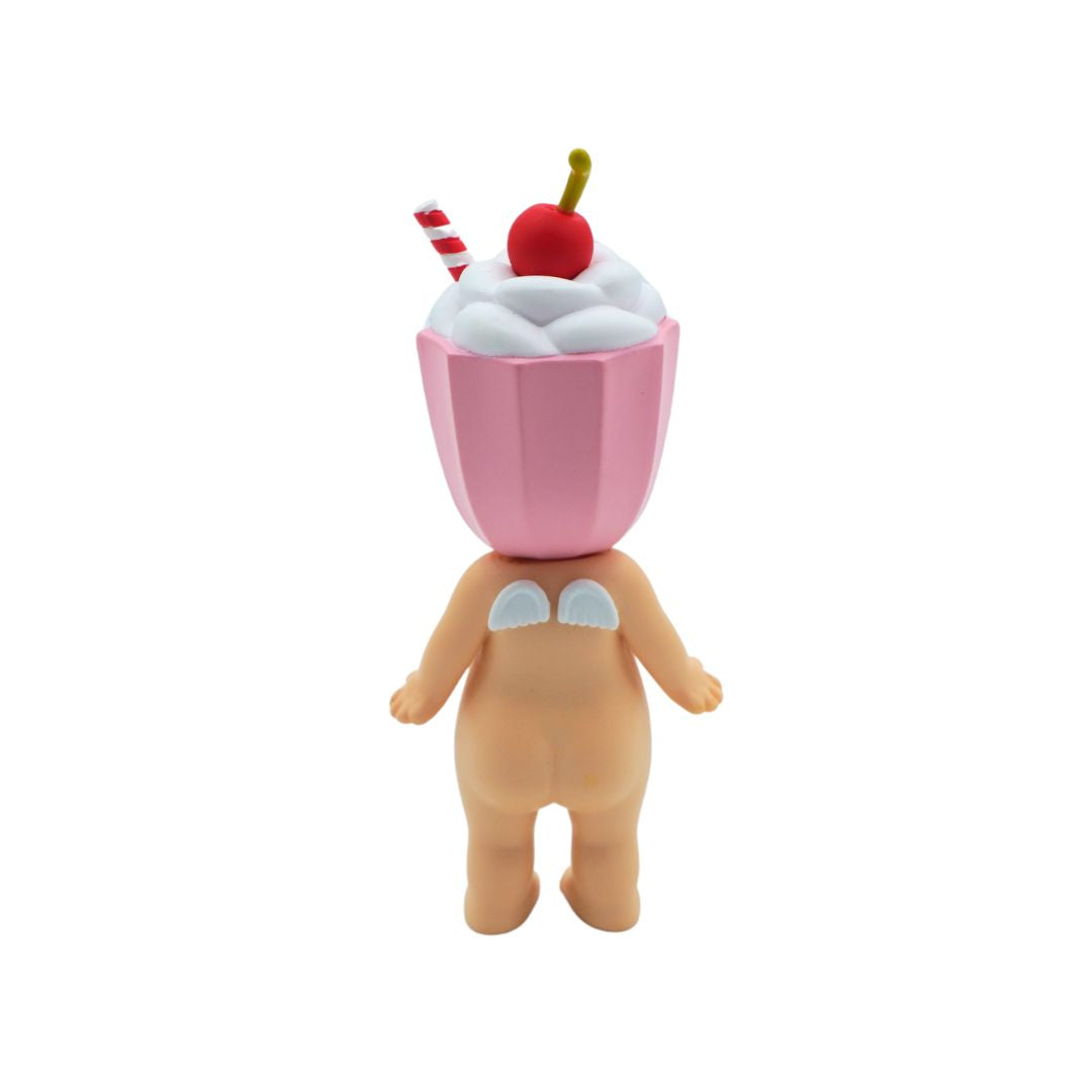 A Sonny Angel with a pink cherry milkshake on its head, photographed against a white backdrop.