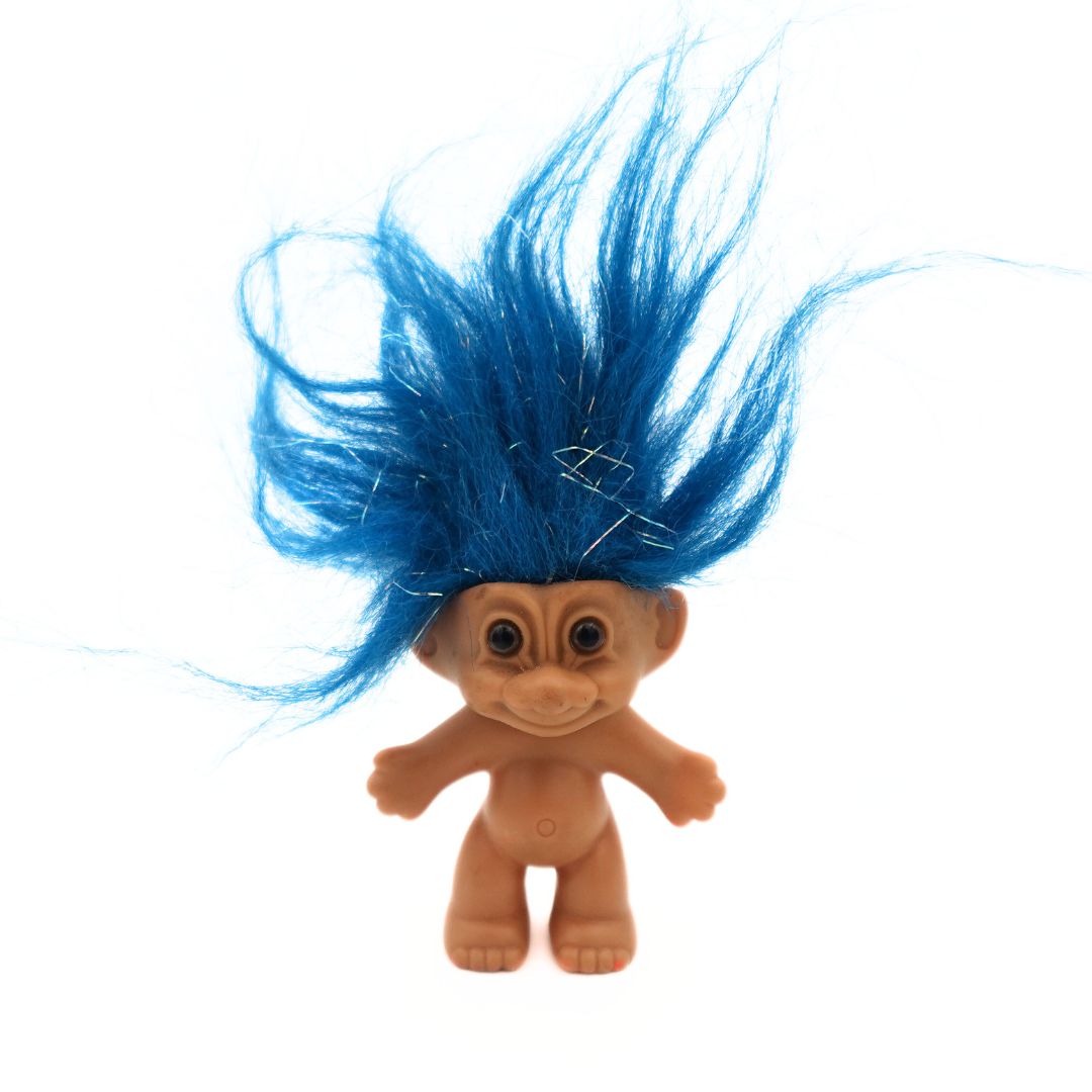 A brown eyed blue haired tinsel detailed 90s Russ Troll Doll