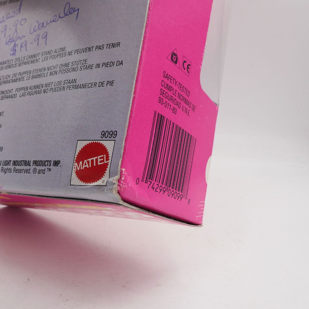 Close-up of a Mattel product packaging with a barcode and safety label.