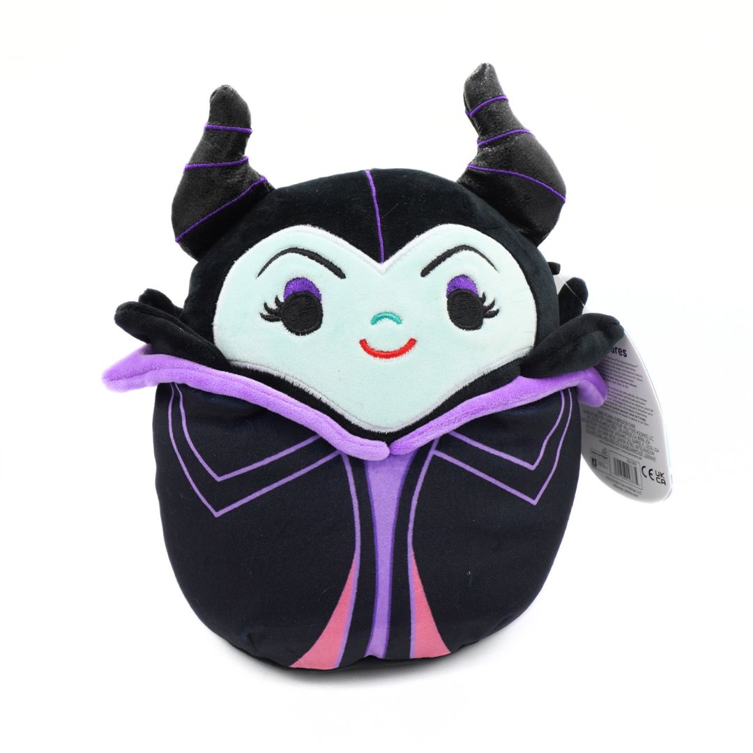 A plush toy of the Disney Maleficent character, styled like a Squishmallows figure, featuring a black body, purple horns and trim, a pale blue face, and embroidered facial features on a white background.