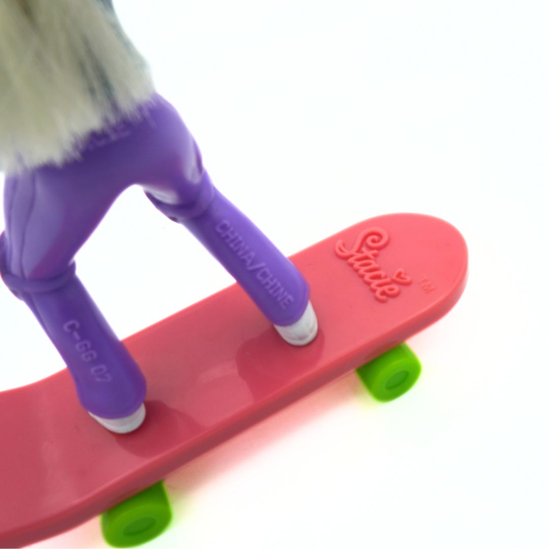 Closeup of the pink skateboard with green wheels released through McDonalds with a Stacie doll