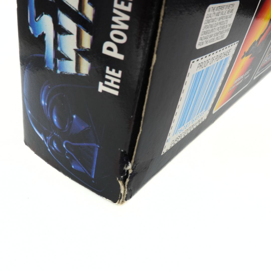 Close-up of a toy packaging corner with text and graphics on a white background