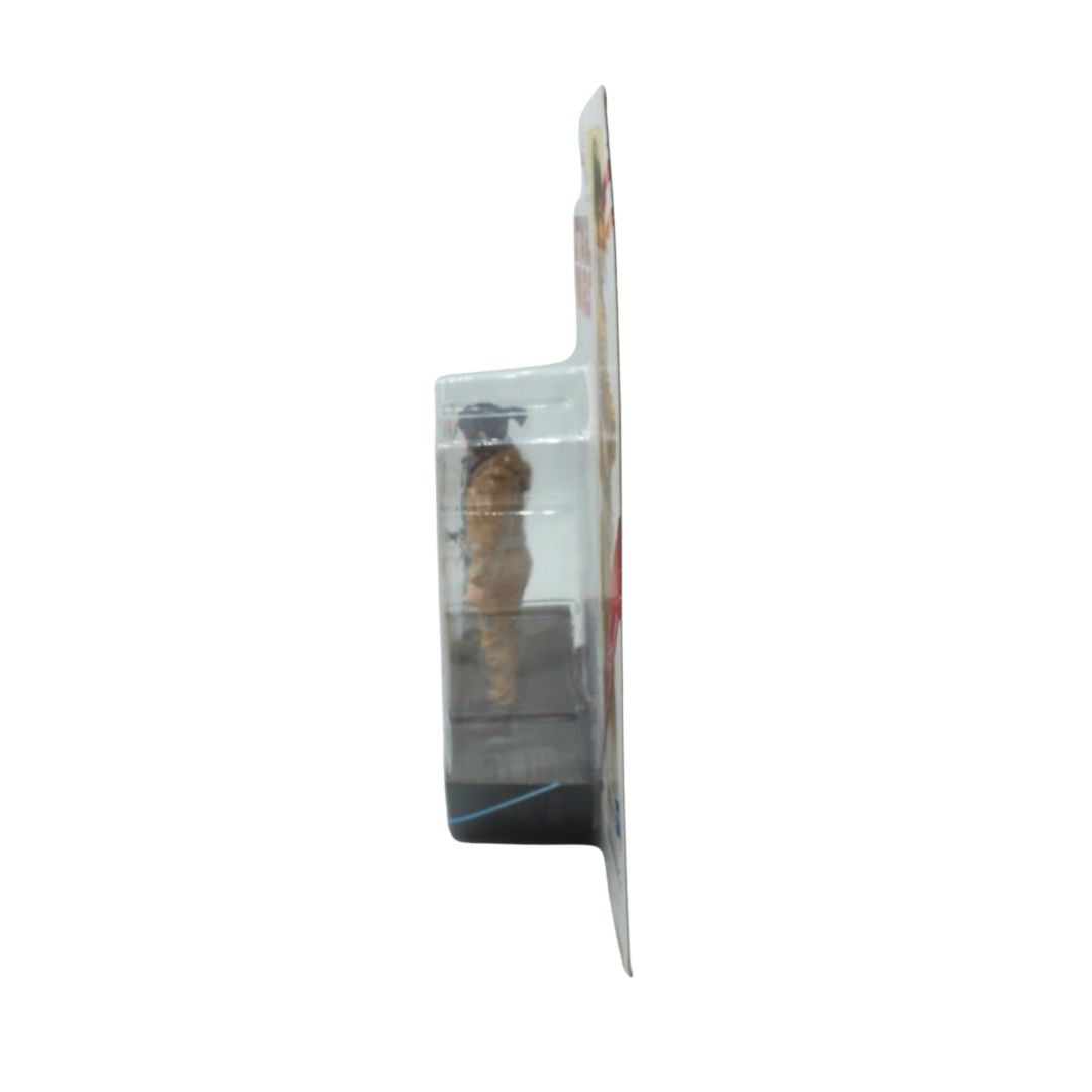 Small figurine in a clear plastic packaging on a white background