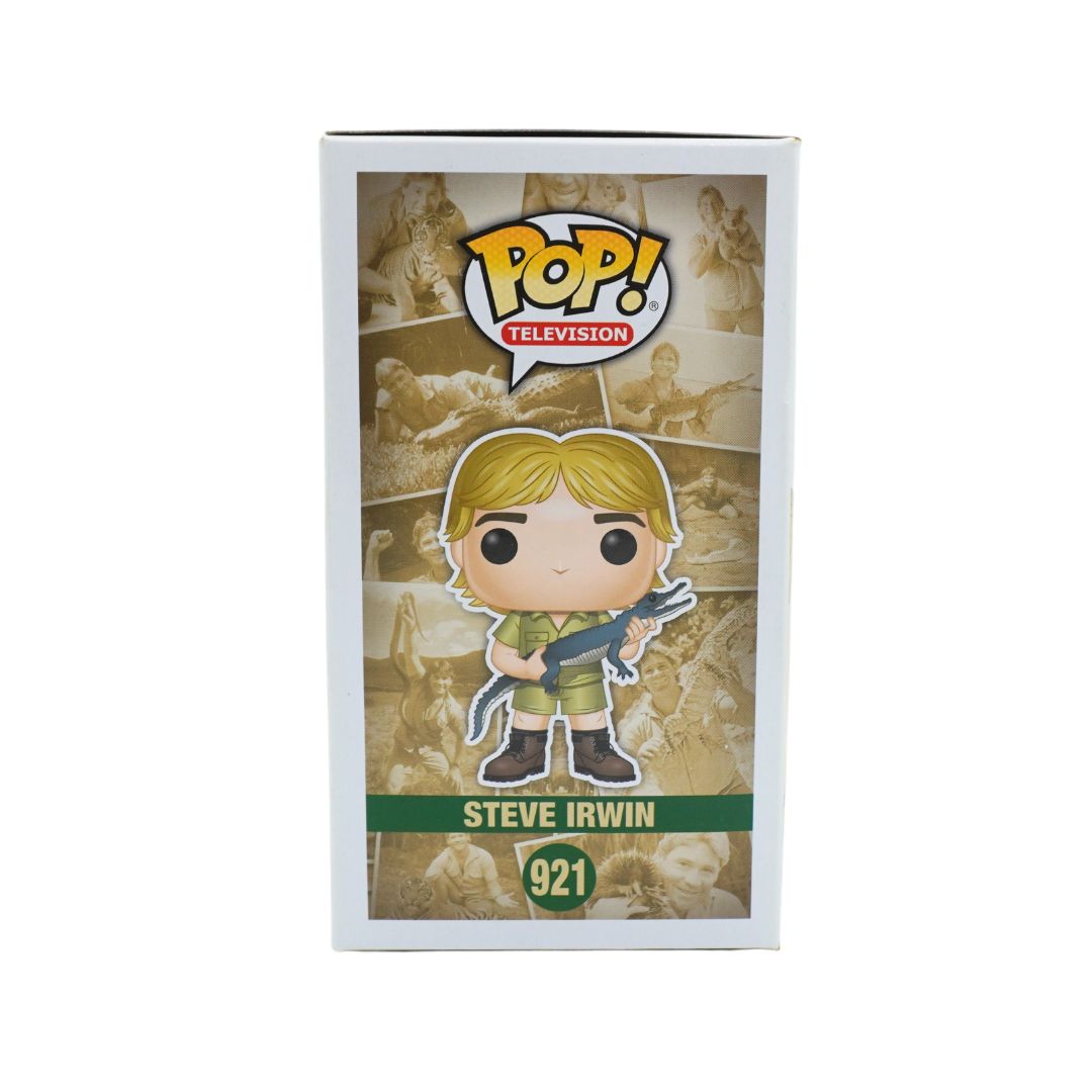 Funko Pop! Television Steve Irwin vinyl figure in its original window box packaging, featuring the character with blonde hair and a rifle, set against a sepia-toned background collage.